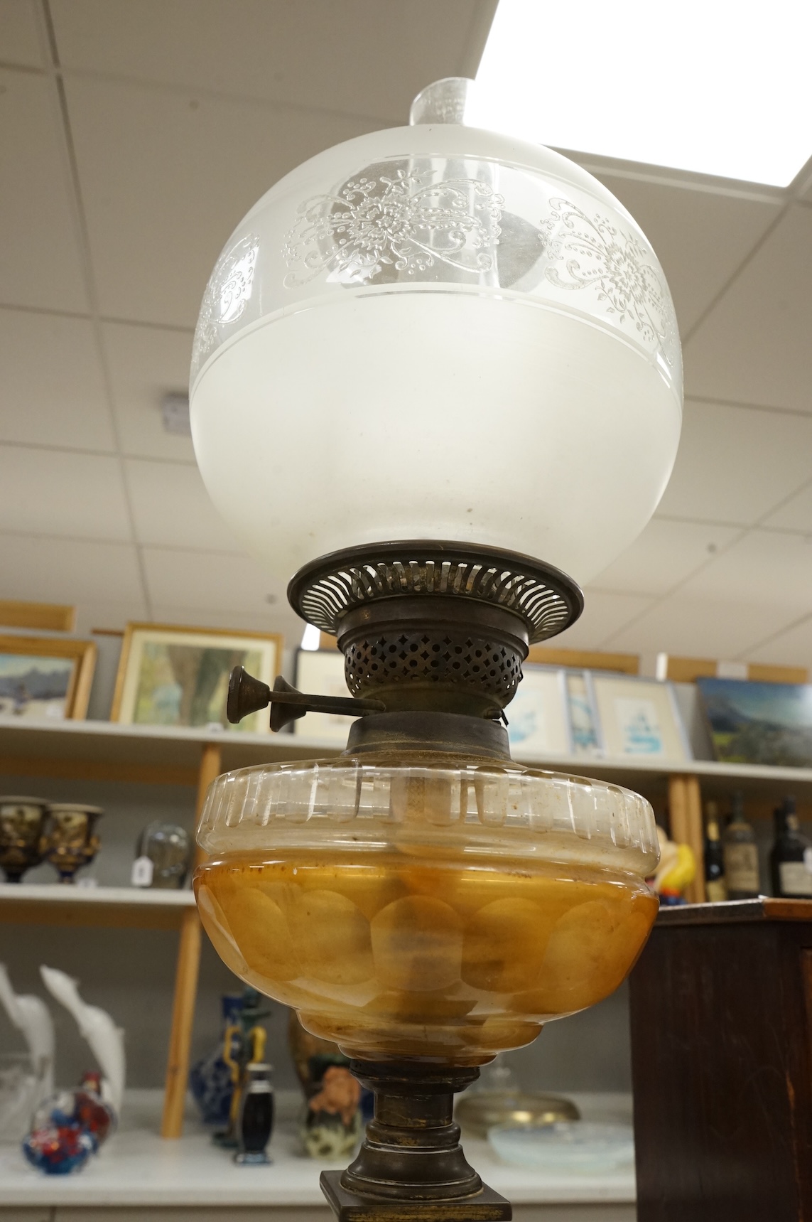 A brass oil lamp with columnar base and etched glass shade, 72cm high overall